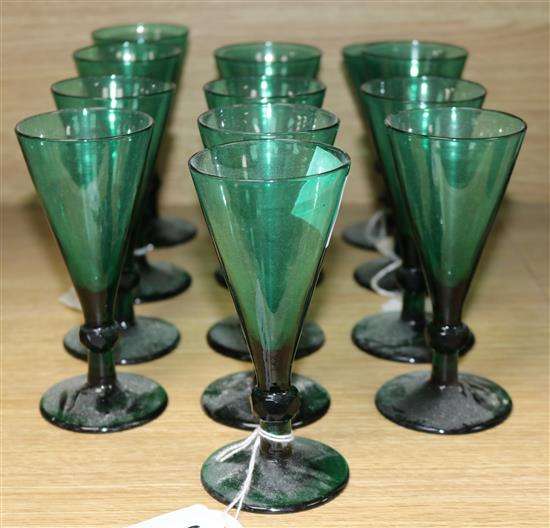 A collection of thirteen assorted 19th century green conical wine glasses	 largest 15cm